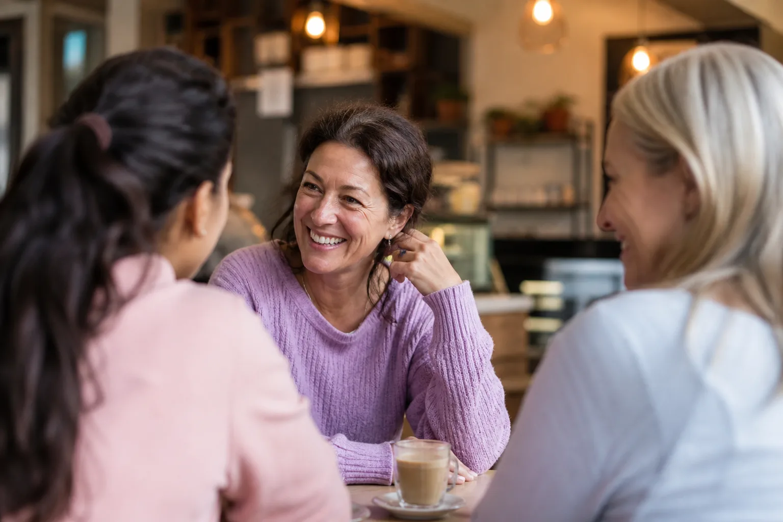 Two adults talking over coffee in a Mid Glamorgan town centre